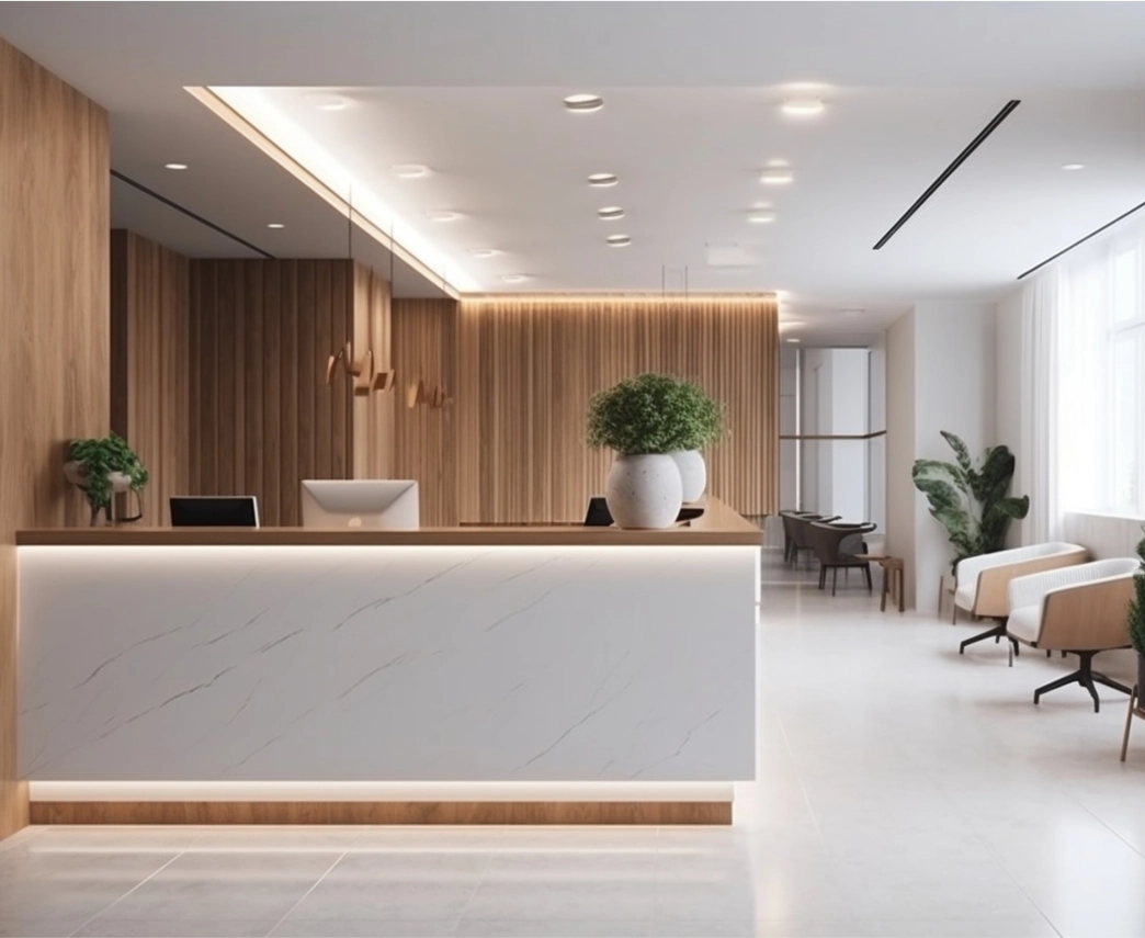 A reception desk at a modern office. Brightly lit, white decor, and custom lighting.