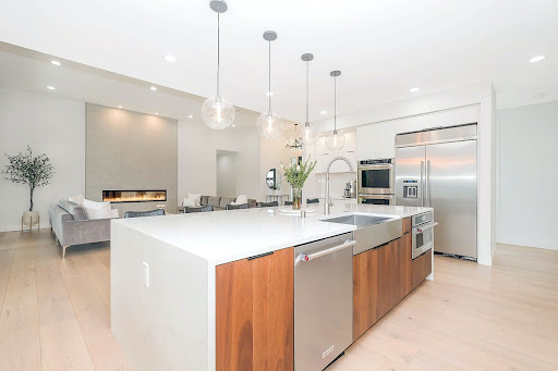 Modern kitchen in Austin, Texas with four electrical lighting fixtures suspended from the ceiling.