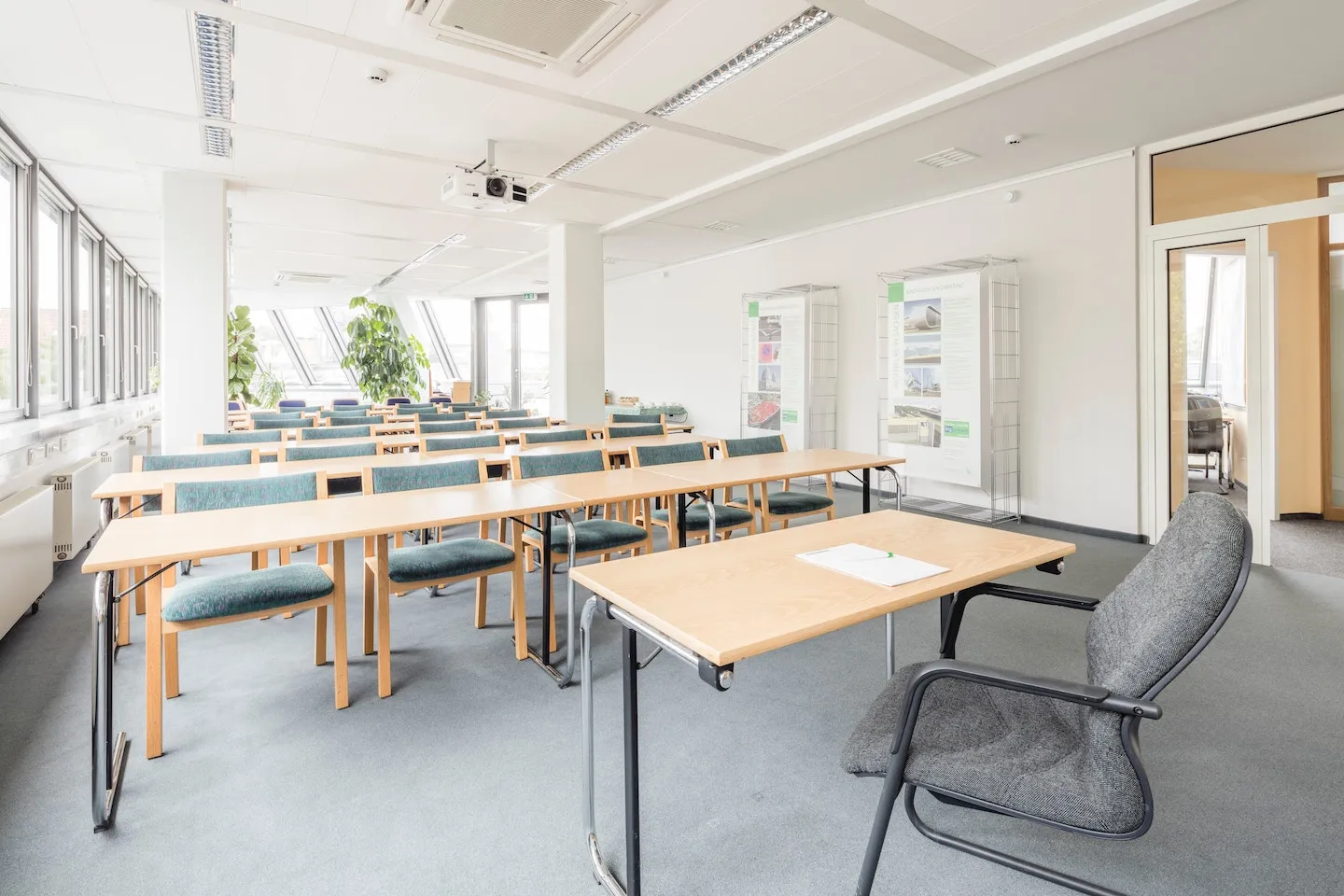 School classroom with commercial fixture installations including overhead lights and projector.