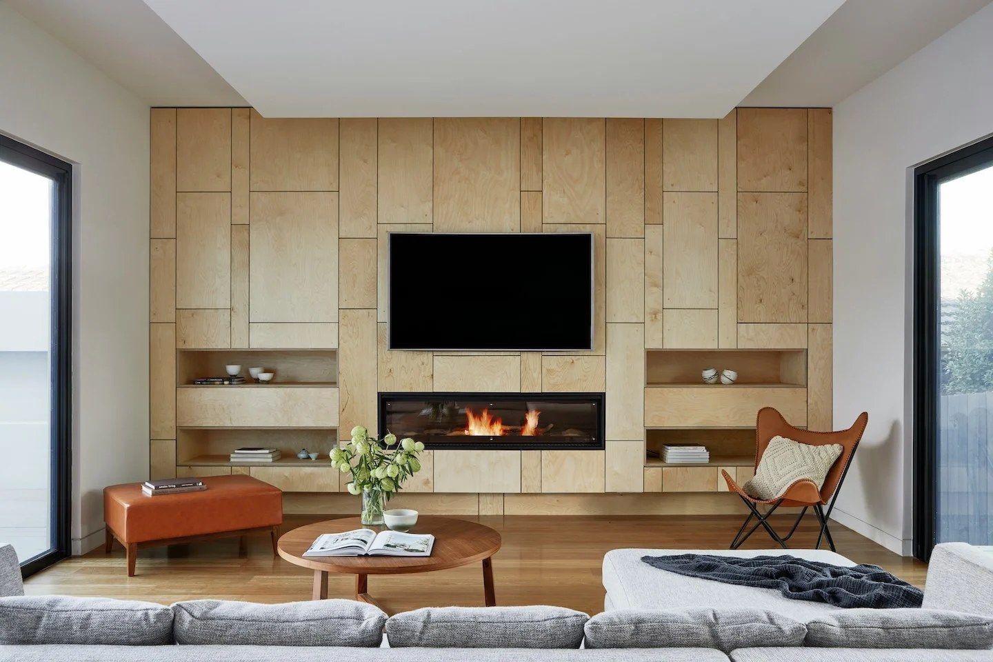 Living room with wooden panel accent wall and electric fireplace.
