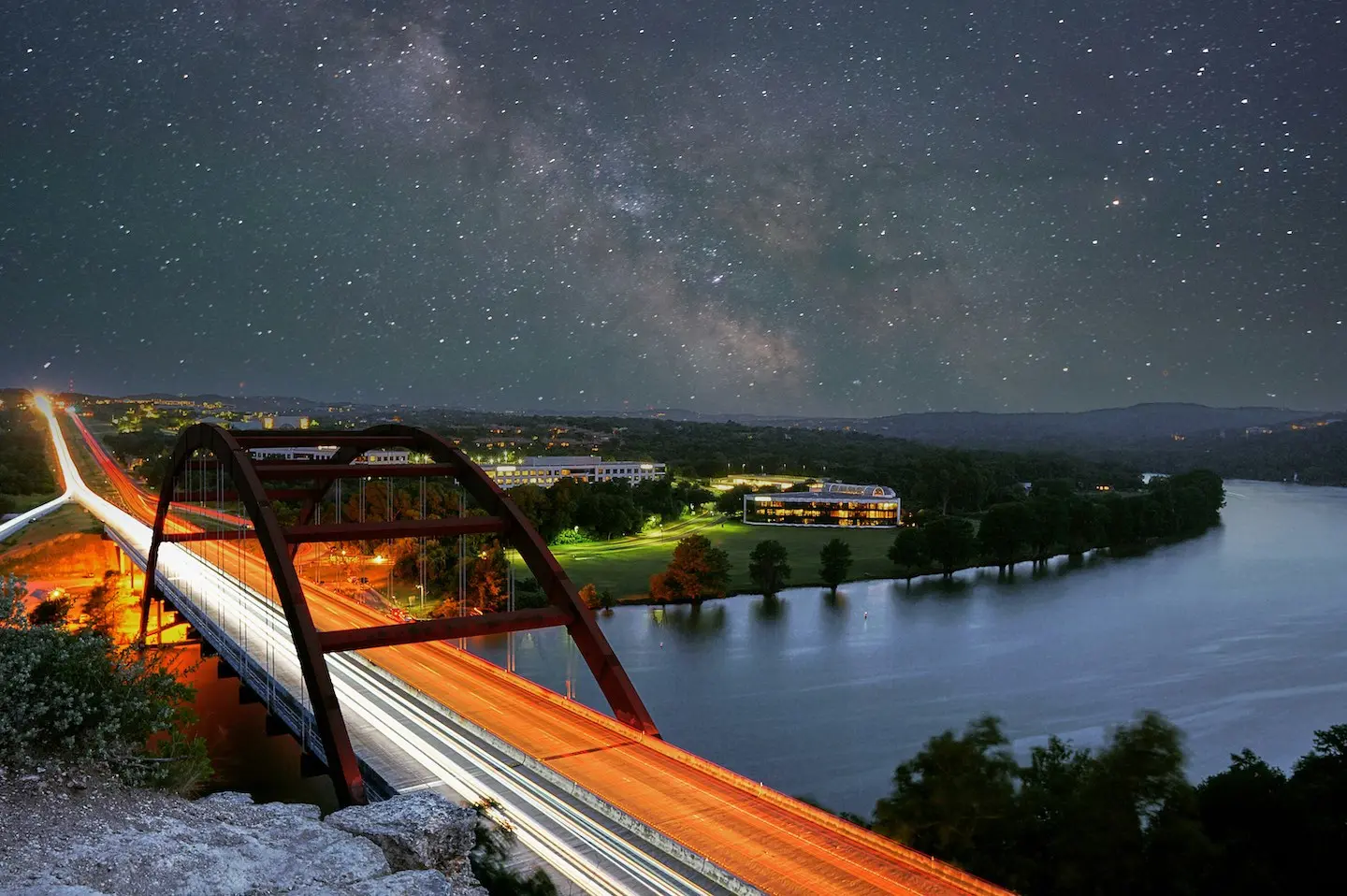 Extended exposure shot of Pennybacker Bridge in Austin with starry sky.