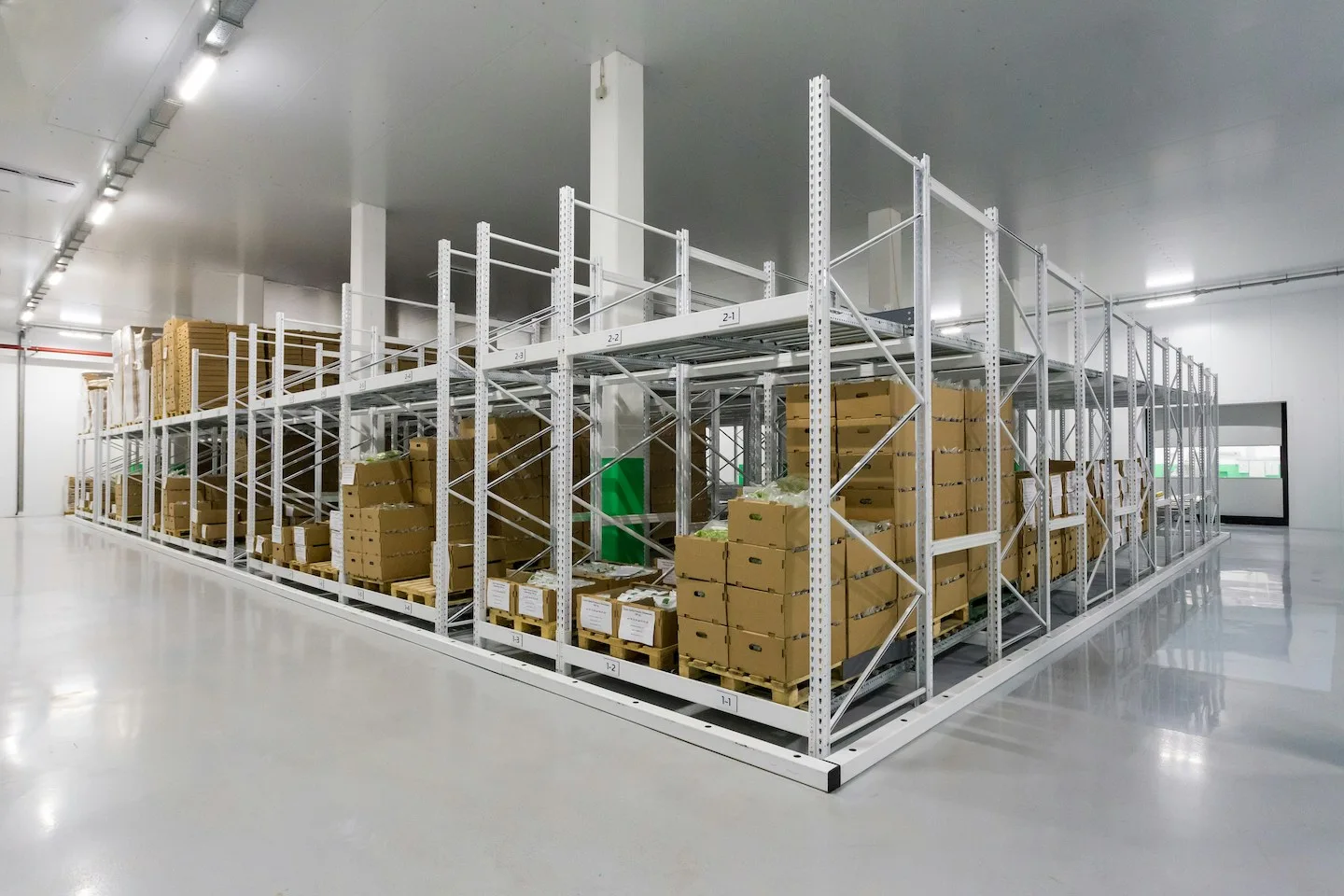 Warehouse storage room with stacked cardboard boxes.