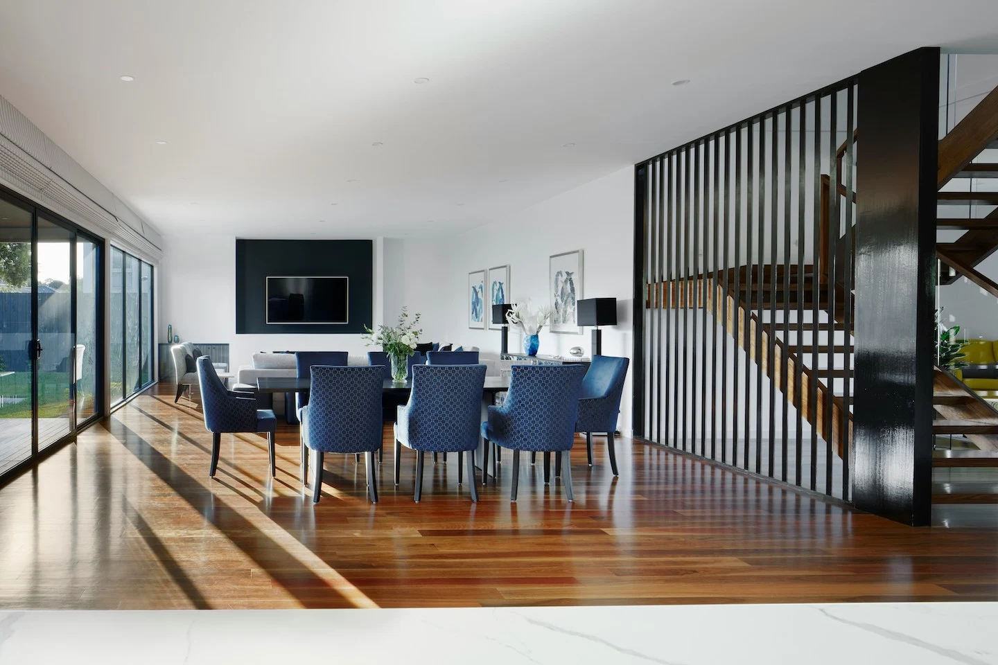 Dining and living room in Austin with floor to ceiling windows.