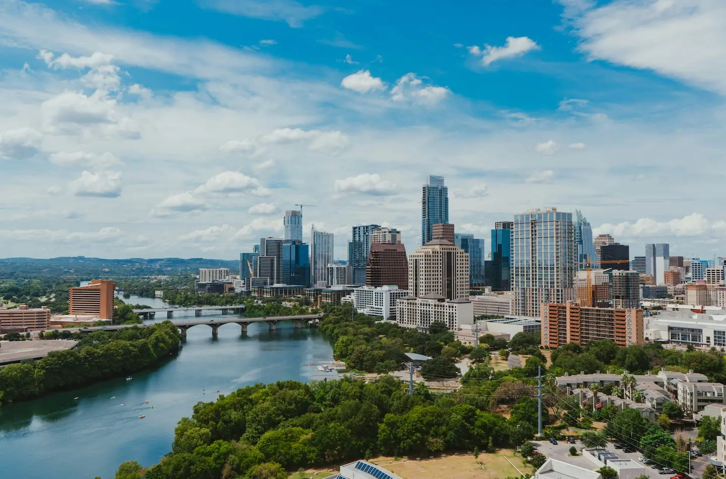 Aerial view of Downtown Austin from Rainey Street district, looking over Lady Bird Lake.