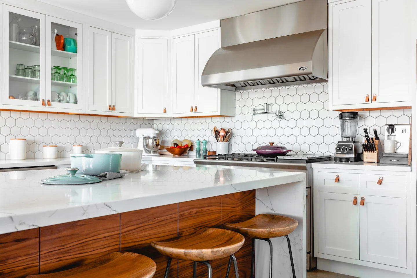 Brightly lit kitchen with white tile and wooden accents inside home in Northeast Austin.