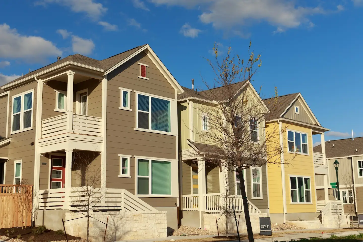 Three condos in Northeast Austin white picket railings and limestone retention walls.